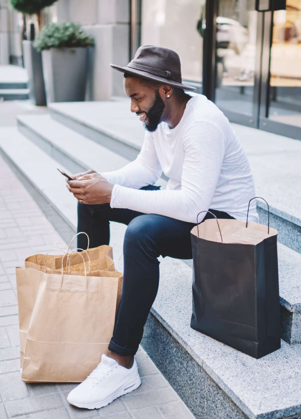 Customer with shopping bags submitting online rebate